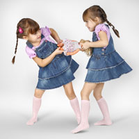 twin girls fighting over a doll