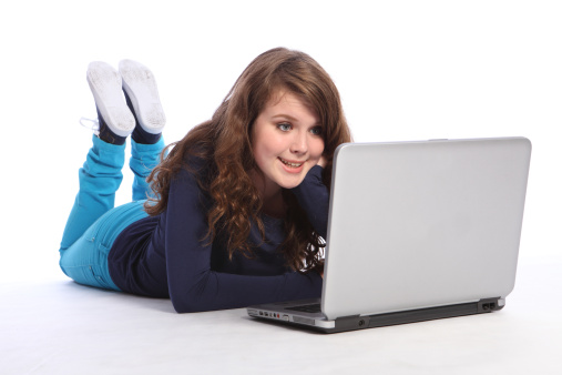 Happy teenager high school girl on internet