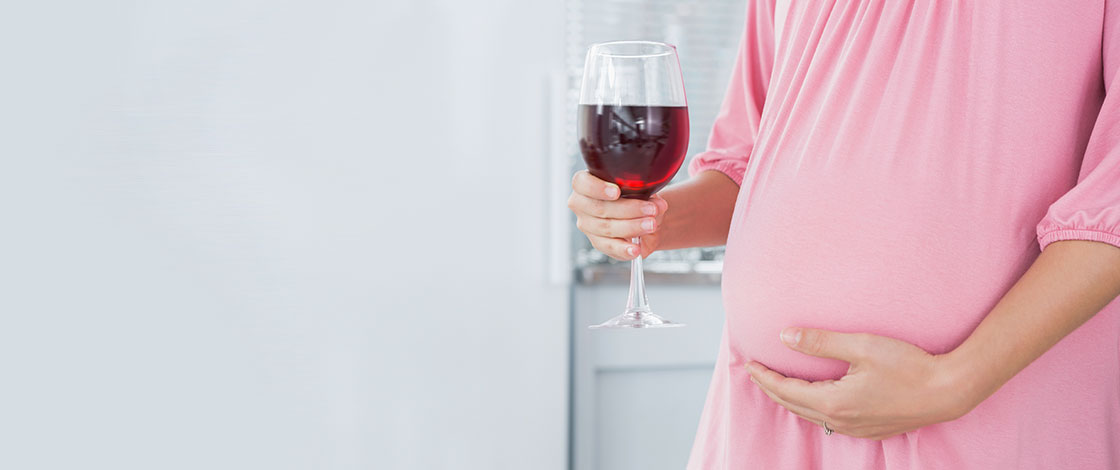 pregnant woman with a glass of wine