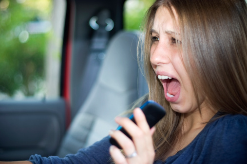 teenage girl screaming in her car while on the phone