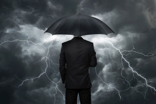 man holding an umbrella in a storm