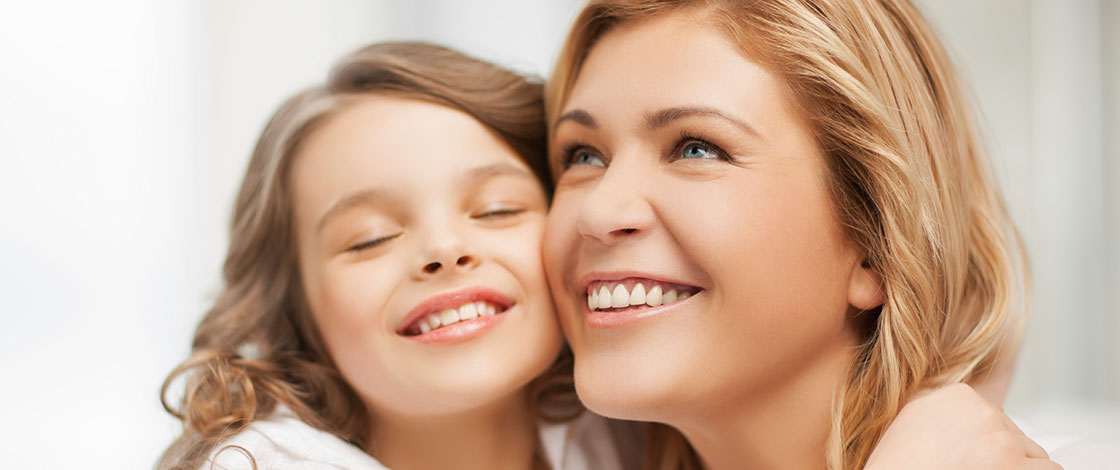 woman smiling with her daughter