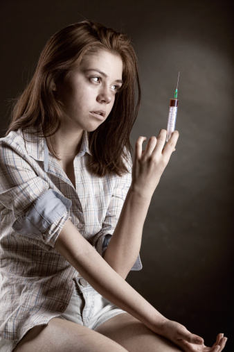 Young woman holding a syringe