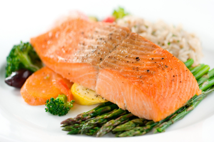 Baked salmon with fresh asparagus and vegetables served with risotto.