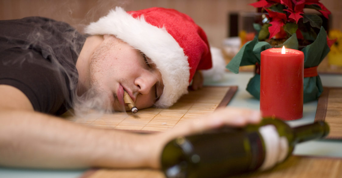 man passed out with a christmas hat
