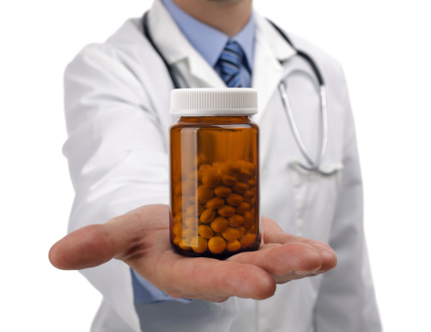 doctor holding pills in his hand