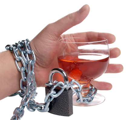 enchained hand holding a wine glass