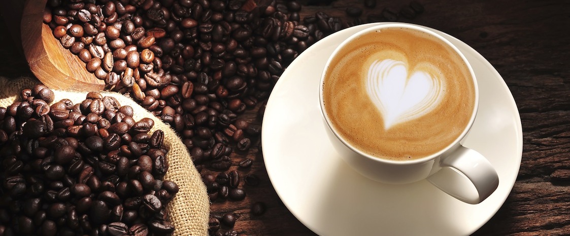 latte next to coffee beans