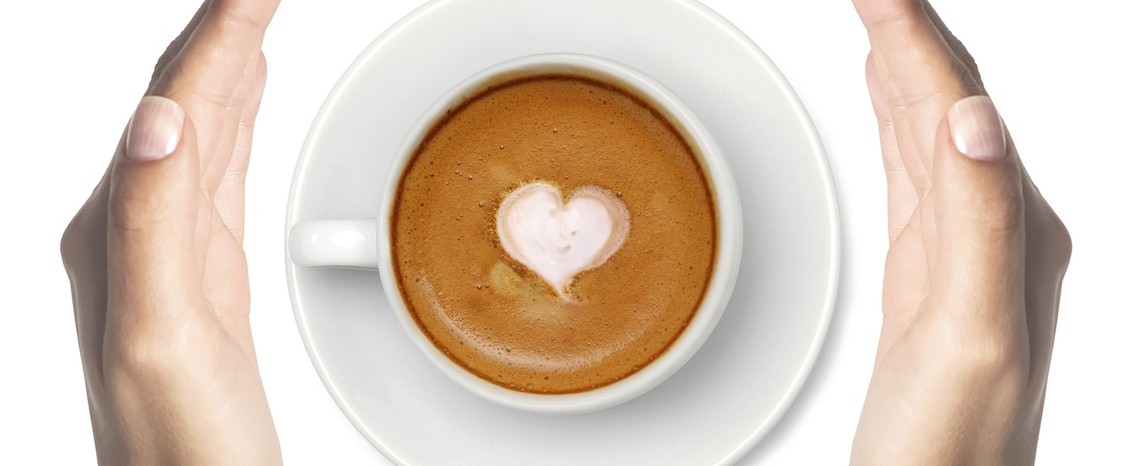 coffee with heart symbol and woman hands