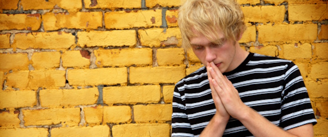 yellow brick wall prayer young adult male