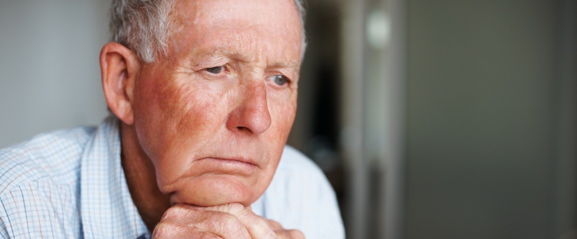 Depressed elderly man lost in thought