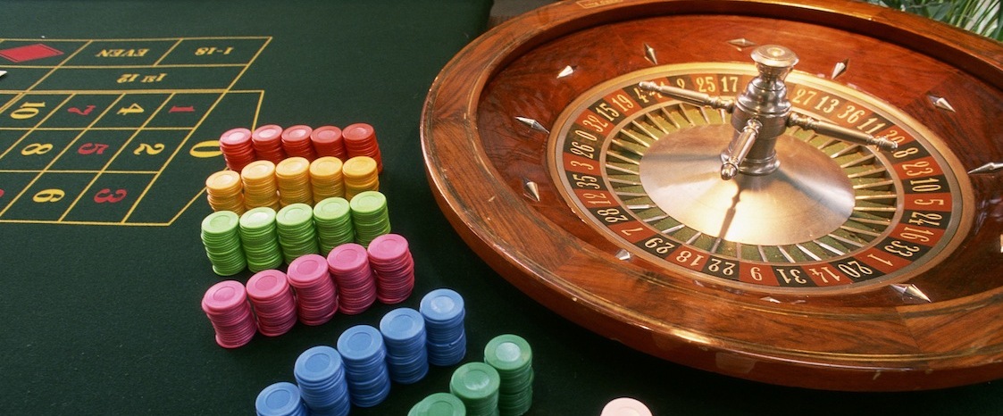Close-up of a roulette wheel with gambling chips in a casino
