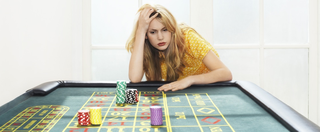 Young Woman Losing At Roulette Table