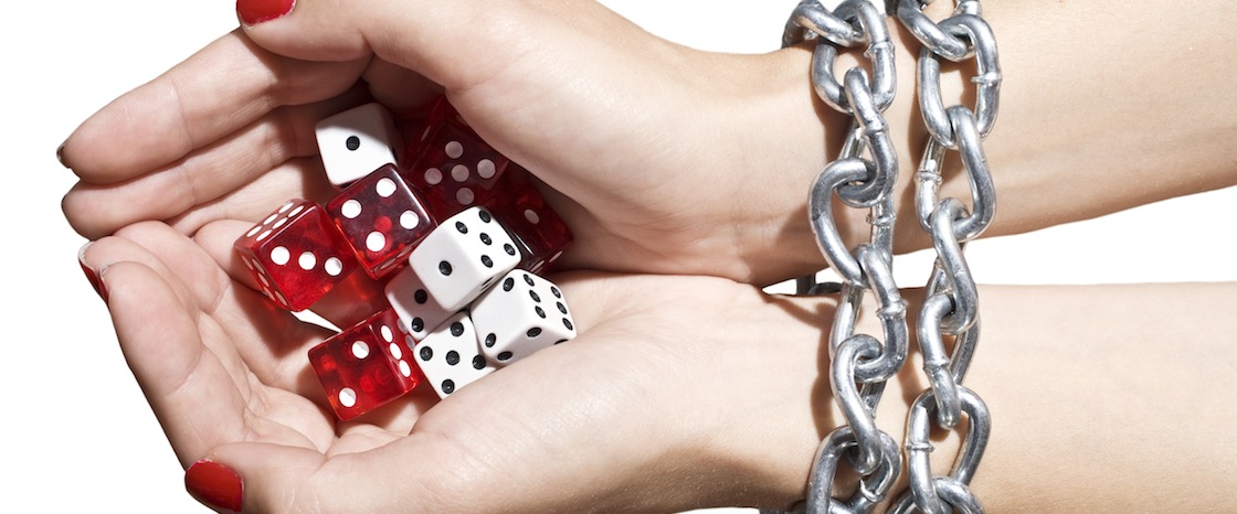 woman holding dice with chains around her wrists