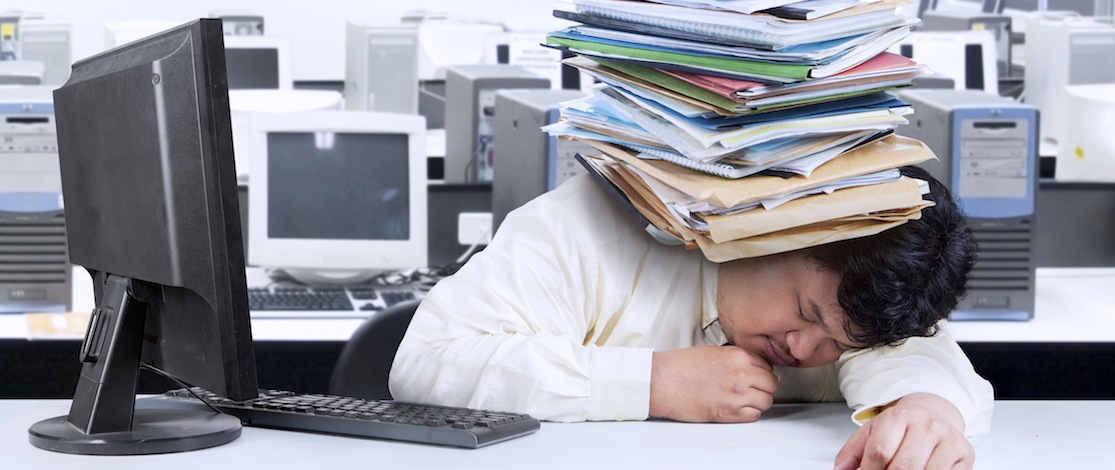 Portrait of overwhelmed fat man sleeping in office with documents on his head